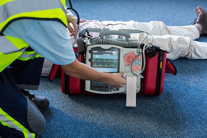 Paramedic using an external defibrillator