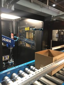 Robotic arm and box on conveyor belt